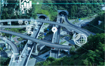 Vista aérea de una autopista moderna con túneles rodeada de vegetación, representando el desarrollo sostenible y la infraestructura inteligente.